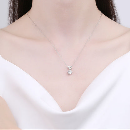 French Heart Four-Claw 1 Carat Moissanite Love Necklace set in Platinum Plated 925 Silver (GRA) Capella Jewellery woman wearing close up