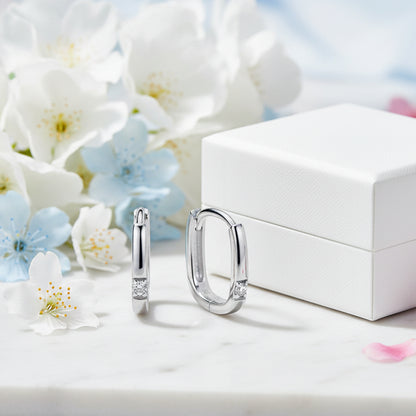 Modern Italian Square Micro Moissanite Earrings set in 18K White Gold Plated 925 Silver (GRA) Capella Reya next to box