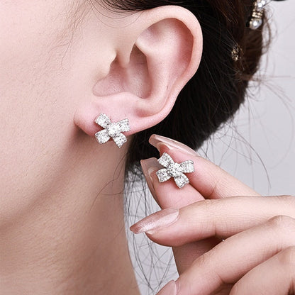 French Bow Design 1 Carat Moissanite Earrings set in Platinum Plated 925 Sterling Silver Capella Reya in ear